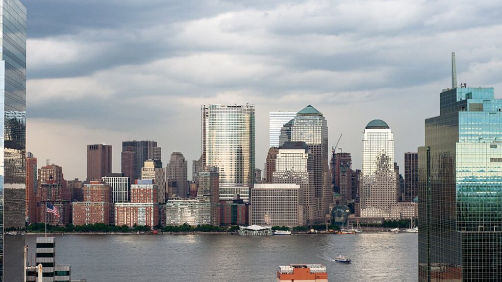 The skyline of a United States financial district at dusk, marking the launch of the ALLJOBSUSA employment platform.