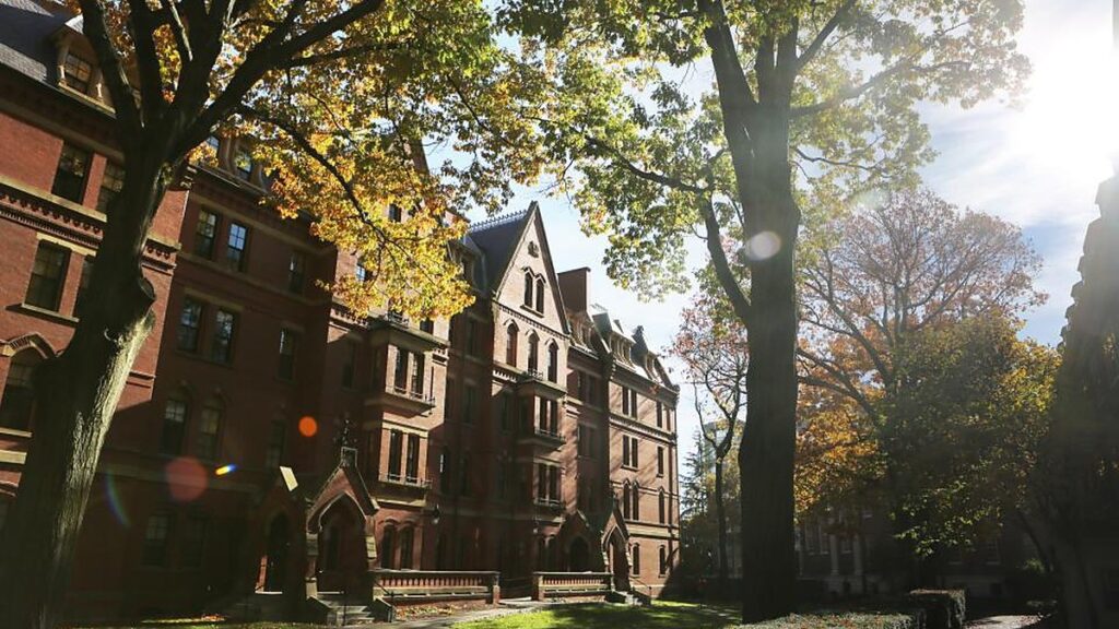 A historic United States university campus lined with trees in autumn light.